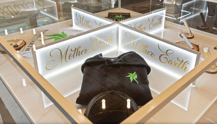 Mother Earth Wellness clothing selection - hoodie in glass case